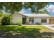 Charming single-story home featuring a metal roof, cozy front porch, and lush green lawn at 2153 Catalina N Dr, Clearwater, FL 33763