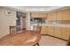 Spacious kitchen featuring tile floors, wooden cabinets, and a cozy eat-in dining area at 2153 Catalina N Dr, Clearwater, FL 33763