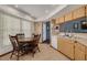 Eat-in kitchen with tile floors, wood cabinets, stainless steel sink, and access to the backyard at 2153 Catalina N Dr, Clearwater, FL 33763