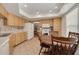 Bright kitchen with wooden cabinetry, tile flooring, and adjacent dining area with a round table at 2153 Catalina N Dr, Clearwater, FL 33763