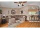 Comfortable living room featuring a large sectional sofa, wood-look flooring, and a ceiling fan at 2153 Catalina N Dr, Clearwater, FL 33763
