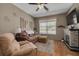 Relaxing living room with a fireplace, TV, comfortable seating, and natural light from the window at 2153 Catalina N Dr, Clearwater, FL 33763