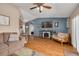 Cozy living room featuring a fireplace, mounted TV, and access to the kitchen and backyard at 2153 Catalina N Dr, Clearwater, FL 33763