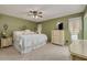 Cozy main bedroom features a ceiling fan, neutral carpet, and a window with natural light at 2153 Catalina N Dr, Clearwater, FL 33763
