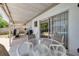Covered patio area, ideal for outdoor seating, relaxation, and entertainment near the pool at 2153 Catalina N Dr, Clearwater, FL 33763