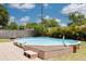 Backyard features an above ground pool surrounded by grass at 2153 Catalina N Dr, Clearwater, FL 33763