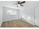 Bedroom featuring wood-look floors, a ceiling fan, and bright light at 2286 Norwegian Dr # 8, Clearwater, FL 33763