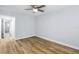 Serene bedroom featuring wood-look floors, a ceiling fan, and natural light at 2286 Norwegian Dr # 8, Clearwater, FL 33763
