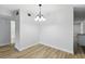 A simple dining area features wood floors, neutral paint, and updated light fixture at 2286 Norwegian Dr # 8, Clearwater, FL 33763