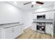 The open kitchen has granite counters, stainless appliances and wood-look flooring at 2286 Norwegian Dr # 8, Clearwater, FL 33763