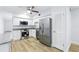 Fully renovated kitchen with granite counters, stainless appliances and white cabinets at 2286 Norwegian Dr # 8, Clearwater, FL 33763