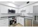 This bright kitchen boasts stainless steel appliances, and white subway tile backsplash at 2286 Norwegian Dr # 8, Clearwater, FL 33763