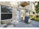 Covered patio with a door, chairs, and an AC unit, offering a comfortable outdoor space at 2286 Norwegian Dr # 8, Clearwater, FL 33763