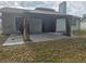 Covered backyard patio area with neutral tones and possible entrance to the house at 23015 Mayfair Rd, Land O Lakes, FL 34639