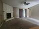 Cozy living room features a stone fireplace, ceiling fan, and sliding glass doors at 23015 Mayfair Rd, Land O Lakes, FL 34639