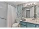 Bathroom with a shower-tub combo, stylish vanity, and modern lighting fixtures at 2400 Winding Creek Blvd # 24-102, Clearwater, FL 33761