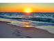Beautiful sunset over the ocean with waves washing onto the sandy beach at 2400 Winding Creek Blvd # 24-102, Clearwater, FL 33761