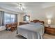 Cozy bedroom with classic wooden furniture, ample natural light, and comfortable carpet flooring at 2400 Winding Creek Blvd # 24-102, Clearwater, FL 33761