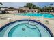 Inviting community pool and whirlpool spa with brick paved deck at 2400 Winding Creek Blvd # 24-102, Clearwater, FL 33761