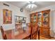 Inviting dining room with a classic china cabinet and a pass-through window to the kitchen at 2400 Winding Creek Blvd # 24-102, Clearwater, FL 33761