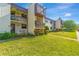 Well-maintained condominium complex with lush landscaping, inviting walkways, and private balconies at 2400 Winding Creek Blvd # 24-102, Clearwater, FL 33761