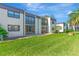 Condos featuring updated windows and doors with lush green space at 2400 Winding Creek Blvd # 24-102, Clearwater, FL 33761