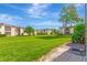 A condo complex with manicured lawn and mature trees under a blue sky at 2400 Winding Creek Blvd # 24-102, Clearwater, FL 33761
