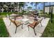 Outdoor grilling area with park benches and a firepit at 2400 Winding Creek Blvd # 24-102, Clearwater, FL 33761
