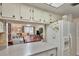 Kitchen overlooking the living room is equipped with modern appliances and ample countertop space at 2400 Winding Creek Blvd # 24-102, Clearwater, FL 33761