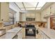 Functional kitchen features a stainless steel range, updated cabinets, and a convenient breakfast bar at 2400 Winding Creek Blvd # 24-102, Clearwater, FL 33761