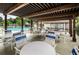 Outdoor seating area featuring tables and chairs overlooking community pool at 2400 Winding Creek Blvd # 24-102, Clearwater, FL 33761