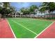 Community tennis courts surrounded by lush landscaping at 2400 Winding Creek Blvd # 24-102, Clearwater, FL 33761