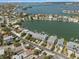 Aerial view of waterfront condos with boat docks and a stunning view of the bay and surrounding neighborhood at 2511 Bay Blvd # B, Indian Rocks Beach, FL 33785