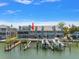 Aerial view showcasing waterfront townhomes with private docks and a shared community pool at 2511 Bay Blvd # B, Indian Rocks Beach, FL 33785