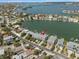 Aerial view of waterfront condos with boat docks and a stunning view of the bay and surrounding neighborhood at 2511 Bay Blvd # B, Indian Rocks Beach, FL 33785