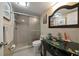 Bathroom featuring a glass vessel sink, sleek cabinetry, and tiled shower at 2511 Bay Blvd # B, Indian Rocks Beach, FL 33785