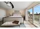 Bedroom featuring comfortable bed, balcony access, and ample natural light for relaxation at 2511 Bay Blvd # B, Indian Rocks Beach, FL 33785