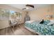 Bright bedroom featuring stylish decor, a ceiling fan, and a large window at 2511 Bay Blvd # B, Indian Rocks Beach, FL 33785