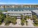 View of condo building featuring multiple units, with balconies and manicured landscaping and easy parking at 2511 Bay Blvd # B, Indian Rocks Beach, FL 33785