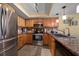 Kitchen featuring stainless steel appliances, wood cabinets, and granite countertops at 2511 Bay Blvd # B, Indian Rocks Beach, FL 33785