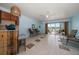 Bright living room with a wet bar, tile floors, and sliding glass doors to the balcony with water views at 2511 Bay Blvd # B, Indian Rocks Beach, FL 33785