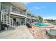 View of the community pool and outdoor entertaining areas with spiral staircases and tiled decking at 2511 Bay Blvd # B, Indian Rocks Beach, FL 33785