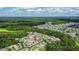 Aerial view of a home's location nestled in a wooded community, near a lake at 25830 Crippen Dr, Land O Lakes, FL 34639