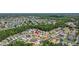 Aerial view showcases the property's location within a lush, green neighborhood with trees and nearby community lake at 25830 Crippen Dr, Land O Lakes, FL 34639