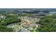 Aerial view showcases home's location within community, near lake and wooded areas at 25830 Crippen Dr, Land O Lakes, FL 34639
