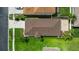 An aerial view of the property shows a manicured lawn, a brown roof, and beautiful landscaping at 25830 Crippen Dr, Land O Lakes, FL 34639
