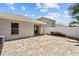 The backyard patio features brick pavers and a view of the white vinyl fence at 25830 Crippen Dr, Land O Lakes, FL 34639
