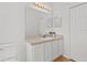 Bathroom featuring a single sink vanity with a large mirror and neutral accents at 25830 Crippen Dr, Land O Lakes, FL 34639