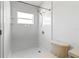 Bright bathroom featuring a white walk-in shower and standard toilet at 25830 Crippen Dr, Land O Lakes, FL 34639