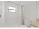 Bathroom featuring a white toilet, shower with a patterned curtain, and neutral walls at 25830 Crippen Dr, Land O Lakes, FL 34639